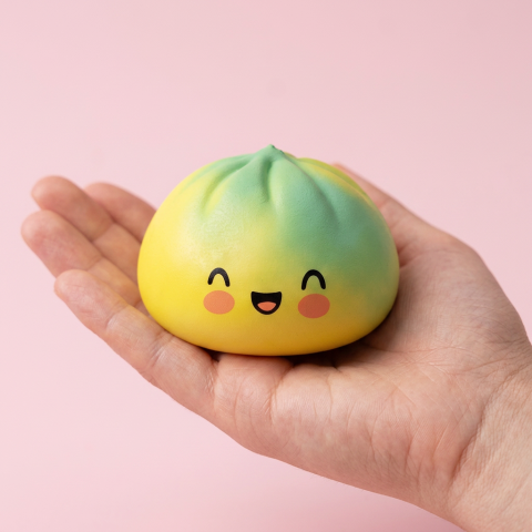 Squishy Dumpling Yellow Fade Zonsondergang in de hand gehouden, echte grootte